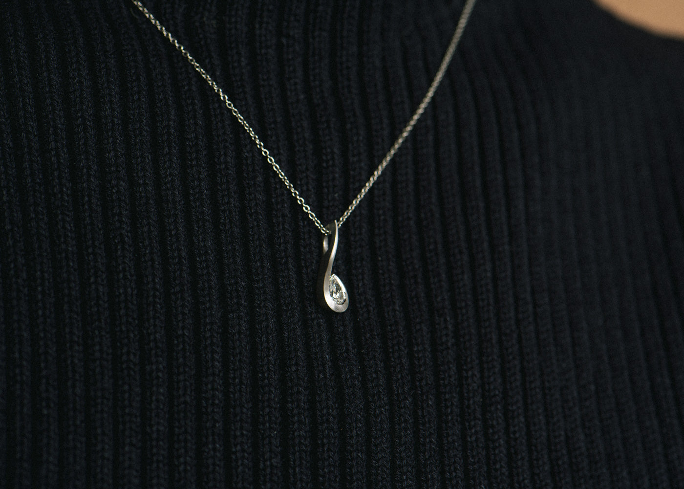 Platinum and pear shaped white diamond Twist pendant